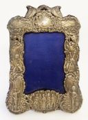 Boer War silver photograph frame with military figures and insignia, in relief with sea scroll