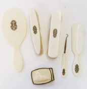 Ivory dressing table set comprising two clothes brushes, hand mirror, shoe horn and button hook,