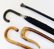 Two bamboo curved-handled walking sticks, metal-handled walking stick and a leather-handled umbrella
