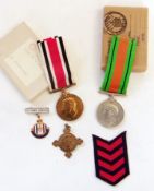 World War II defence medal, boxed, a police medal for Claud. D. T Owen, boxed, and other badges (1