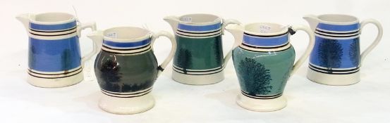 Five 19th century mochaware jugs, 11.5cm high (af)