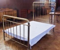 Brass double bedstead with iron frame, rail ends on castors