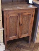 20th century oak bedside cabinet of panelled doors enclosing shelving space, on tapering supports,