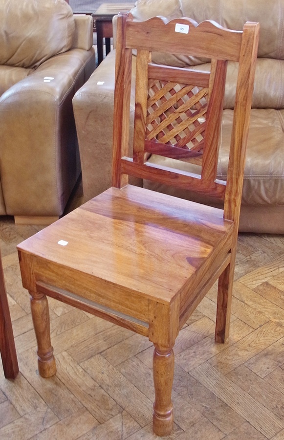 Set of four foreign hardwood dining chairs, each with shaped toprail, lattice pierced back, panelled