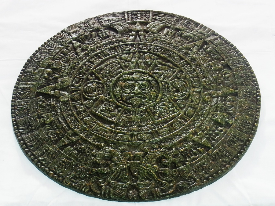Eastern embossed composition panel of Indian style, circular with mask to centre