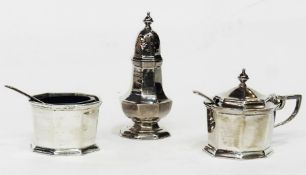 1980's three-piece silver cruet set of octagonal form with blue glass liners, viz:- salt, pepper and