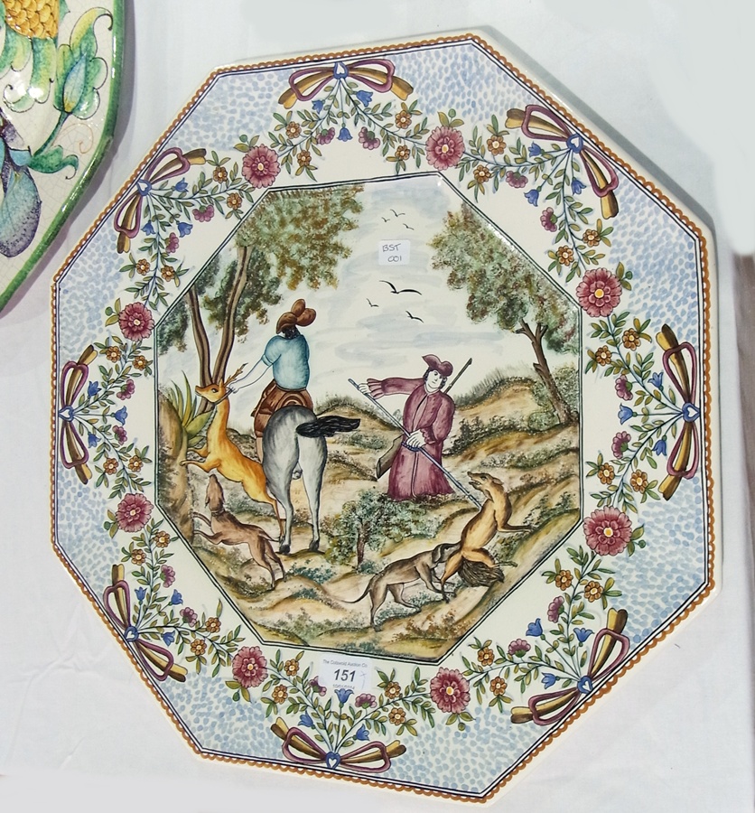 Portuguese pottery wall plaque, octagonal, the centre painted with figures on horseback hunting deer