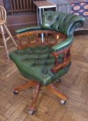 Modern green leather studded and mahogany swivel office chair, on cabriole supports and castors