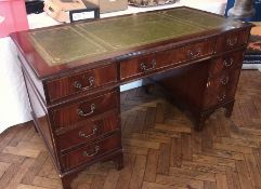 Reproduction mahogany desk, with inlaid pedestal inset leather writing top, an arrangement of nine