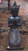 A 20th Century black painted terracotta kneeling Buddha, 64cm high