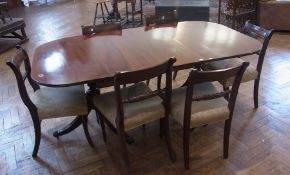 Modern mahogany extending dining table on turned column support, splayed reeded legs, metal claw