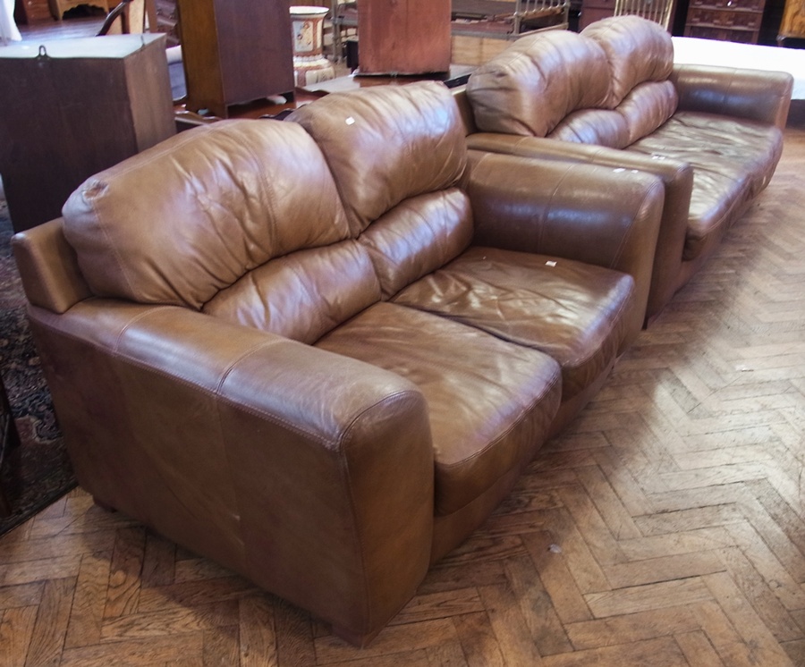 Three seater brown leather settee and a matching two seater settee