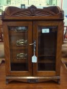 An Edwardian oak table top cigar cabinet, "presented to Mr G Green from the members of the