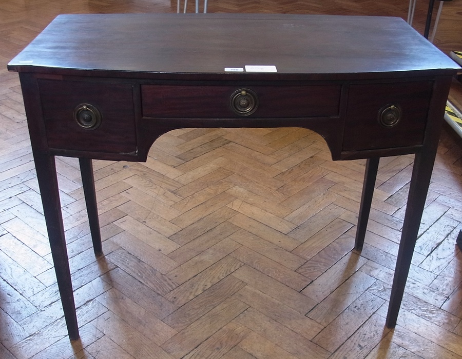19th century mahogany bowfronted side table table, with circular brass ring handles on tapering