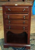 Modern mahogany cabinet with four drawers with drop handles and cupboard space below on bracket