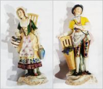 Pair of continental porcelain figures of Grape Harvesters in 19th century dress, each on gilt scroll