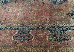 A Persian design Grosvenor Wilton carpet with blue floral spray border, blue central medallions