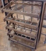 A 20th Century light oak boot holder on casters, 84cm wide