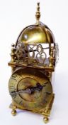 20th century brass lantern style clock, with engraved and pierced dolphin pediment, French movement,