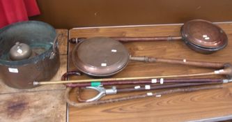 Two copper warming pans, trumpet, three walking sticks, bell and copper pot and other items (8)