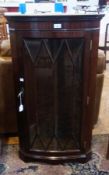 A modern mahogany wall hanging corner cupboard, with dentil cornice, and an astragal glazed door