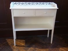 Modern white painted cabinet with two freeze drawers above, cupboard space on tapering supports,