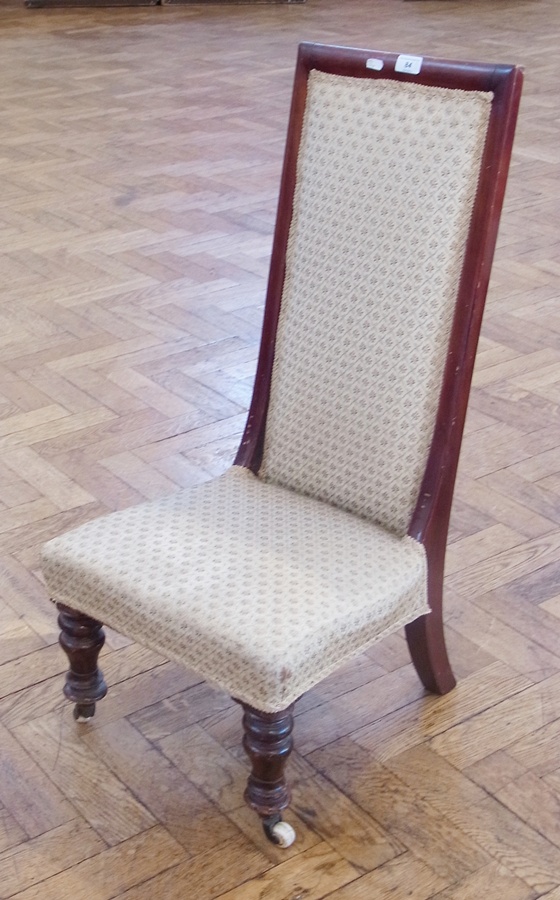 Mahogany nursing chair with padded back and seat, on ring turned supports and ceramic castors