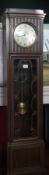 Edwardian oak longcase clock with hinged panel front and astragal glazed door revealing pendulum,