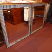 A pair of gilded bevelled plated wall mirrors