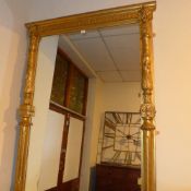 A C19th giltwood overmantle mirror the rectangular plate within moulded and carved frame with lion