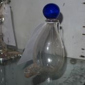 An English 1850 hand blown bird waterer having a blue glass ball knop and ribbed body