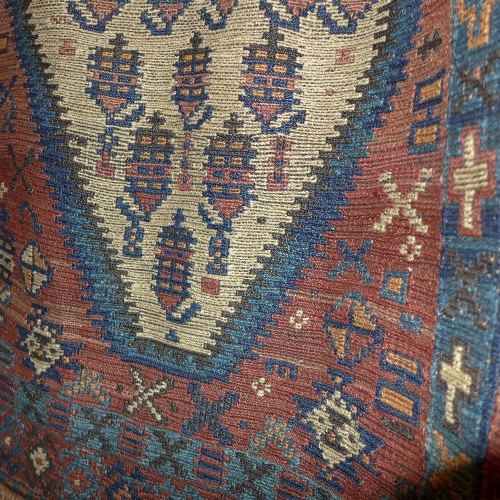 A Persian Kilim runner the blue and beige field decorated with geometric motifs