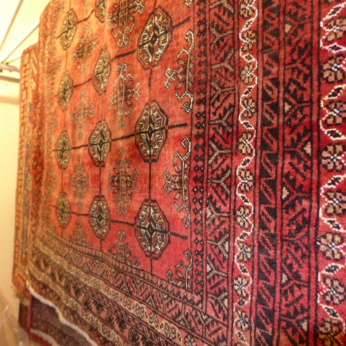 An extremely fine North East Persian Turkoman rug with repeating goul motifs on a terracotta field