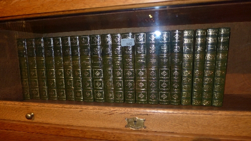 A collection of hard bound books including some works of Dickens