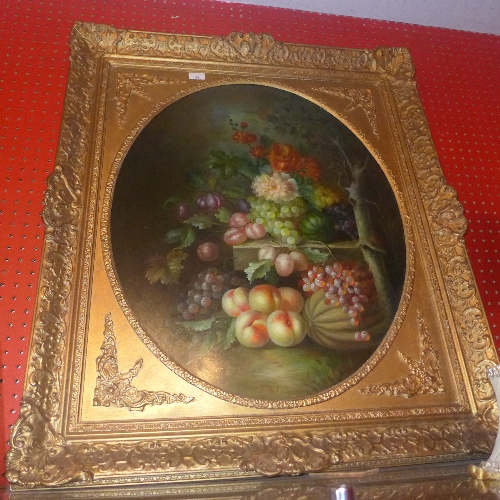 An oil on board still life with fruit and flowers on a table in giltwood frame
