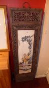 A pair of large Chinese porcelain plaques in carved and pierced wooden frames of a fisherman and