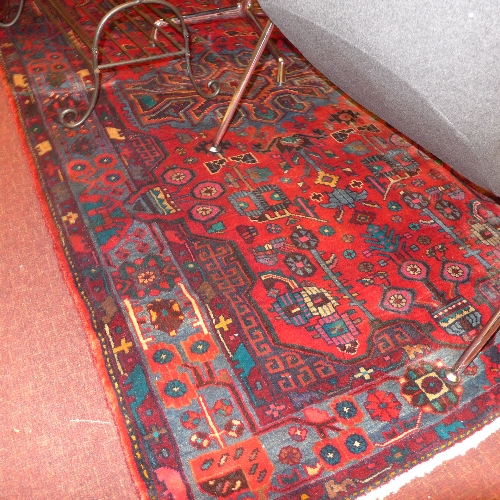 A fine North West Persian Nahawand rug central pole medallion with repeating floral motifs on a