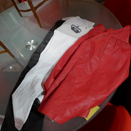 A pair of Victoria Beckham jeans a red leather skirt and a pair of ladies black leather trousers