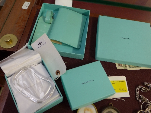 A boxed Tiffany passport and luggage tag with a boxed Tiffany glass crystal trinket box