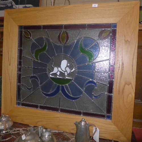 A stained glass window within oak frame