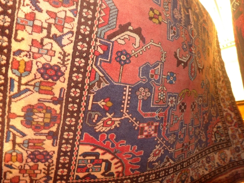 A fine North West Persian Tafresh rug  central pole medallion on a rouge field within stylized