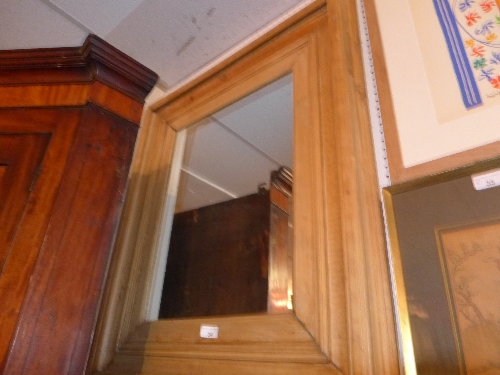 A rustic pine wall mirror with rectangular bevelled plate