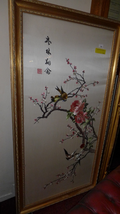 A large Japanese silkwork panel decorated with birds amongst blossom in a gilt frame H 158 x W 84