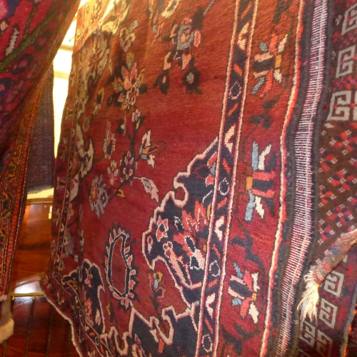 A Persian hand knotted Bakhtia rug the dark rouge field with allover floral decoration L 230 x W