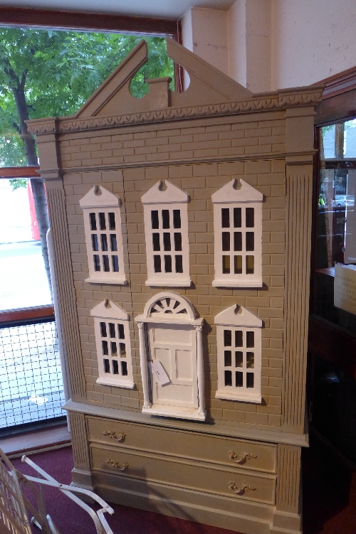 A painted and distressed finish dolls house bookcase fitted pair of panel doors above two base