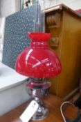 A paraffin lamp with red shade