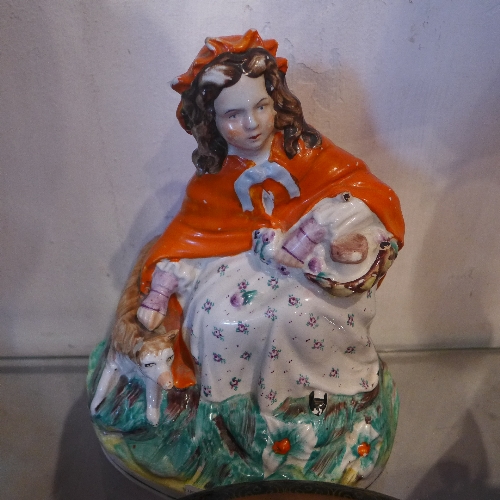 A Staffordshire figural group of a lady with her dog  H 22 cm