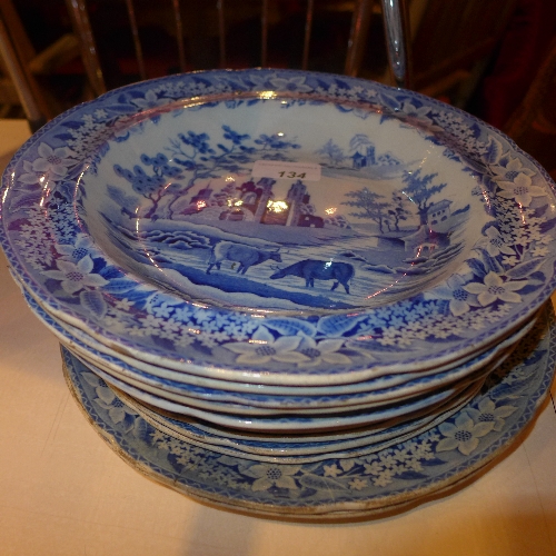 A collection of blue and white soup bowls and plates