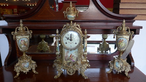 A gilt metal clock garniture with porcelain plaques H 32-42 cm