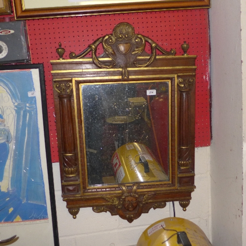 A late C19th and parcel gilt pier mirror with mask detail